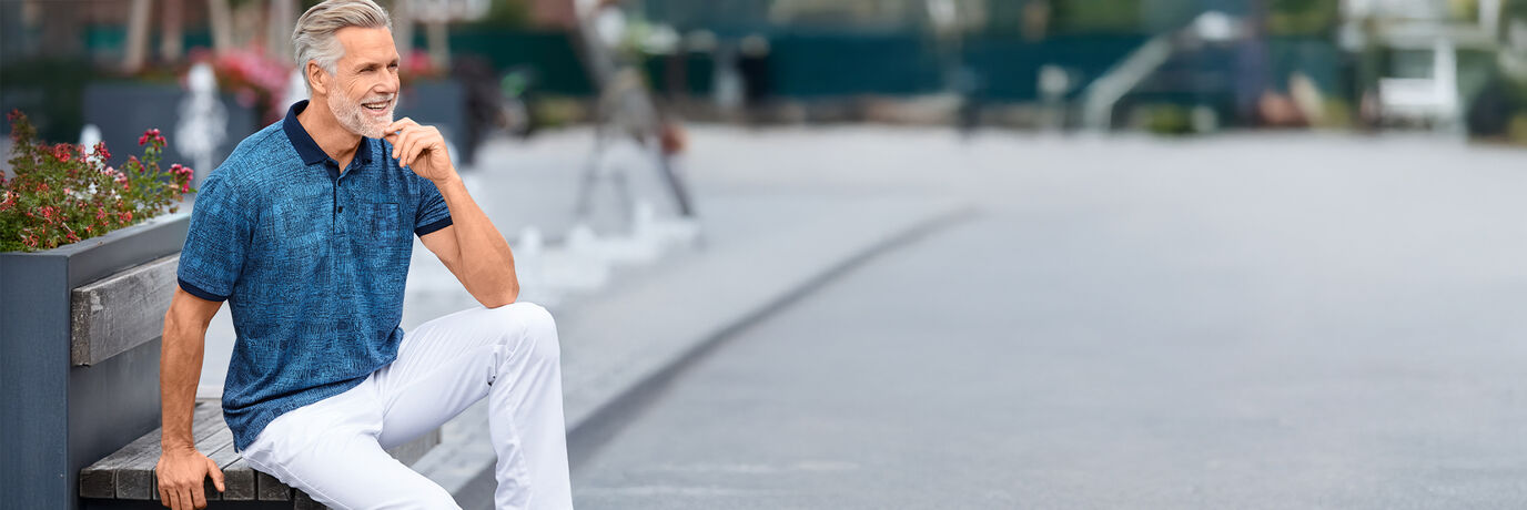 Mann mit blauem Shirt und wei&szlig;er Hose